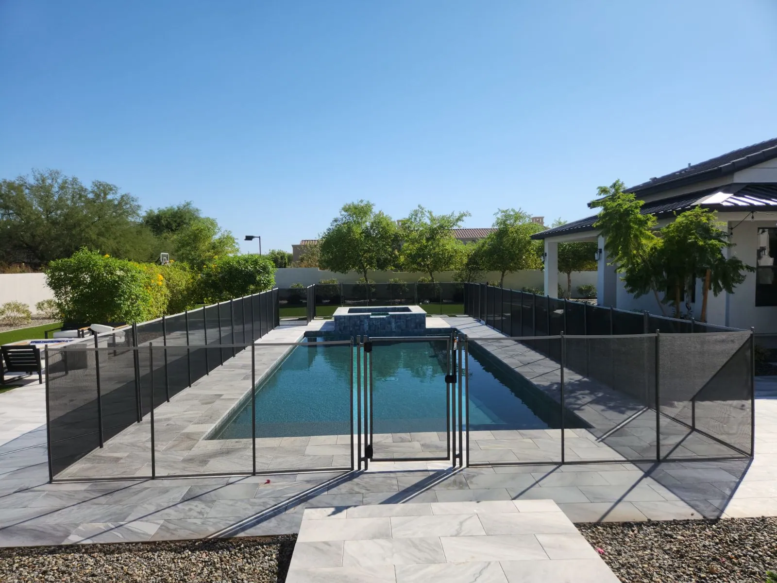 Installed mesh fence and gate around a residential pool