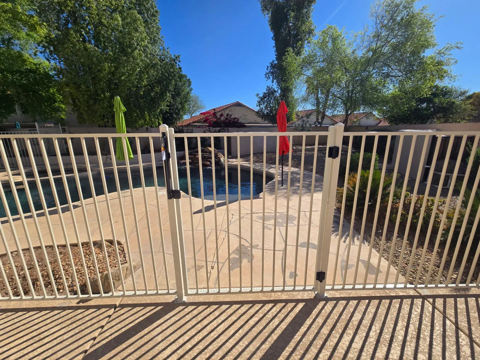 Installed pool gate example showing access between patio and swimming pool